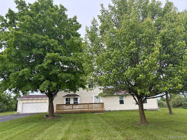 10093 Shepherd Rd, Onsted, MI 49265 - view of front facade featuring a garage, a wooden deck, a front lawn, and asphalt driveway