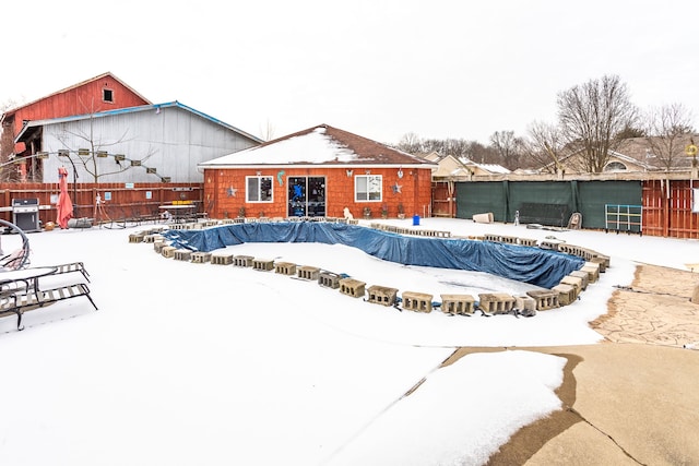 snow covered pool with a grill