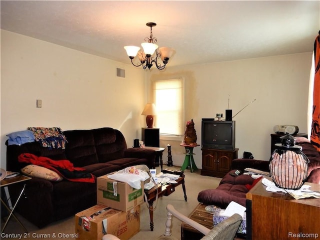 living room featuring light colored carpet and a chandelier