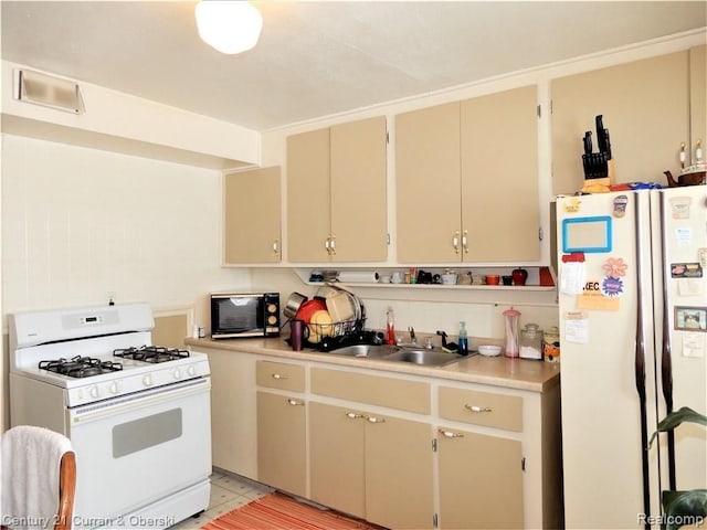 kitchen featuring sink and white appliances