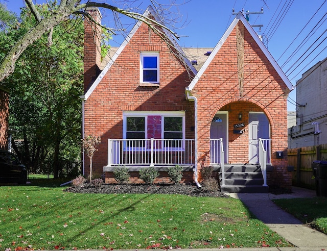 english style home with a front yard