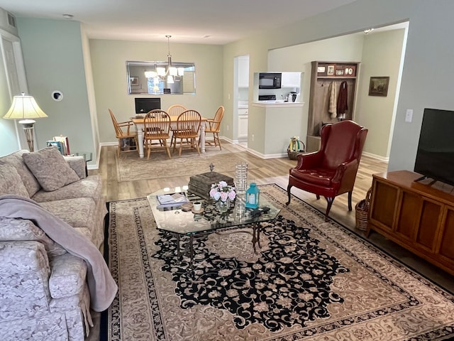 living room featuring hardwood / wood-style floors and a notable chandelier