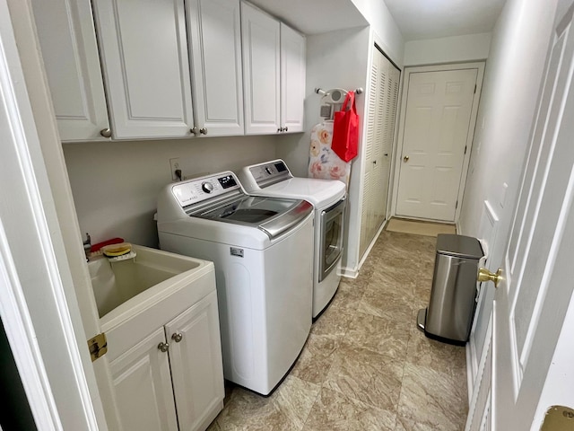 washroom with independent washer and dryer, sink, and cabinets