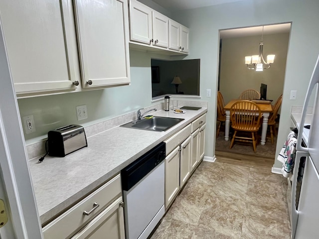 kitchen with decorative light fixtures, sink, white cabinets, a chandelier, and stainless steel dishwasher