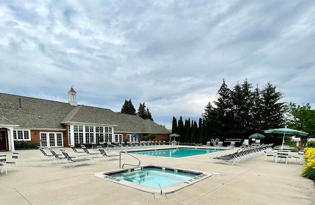 view of pool featuring a community hot tub and a patio