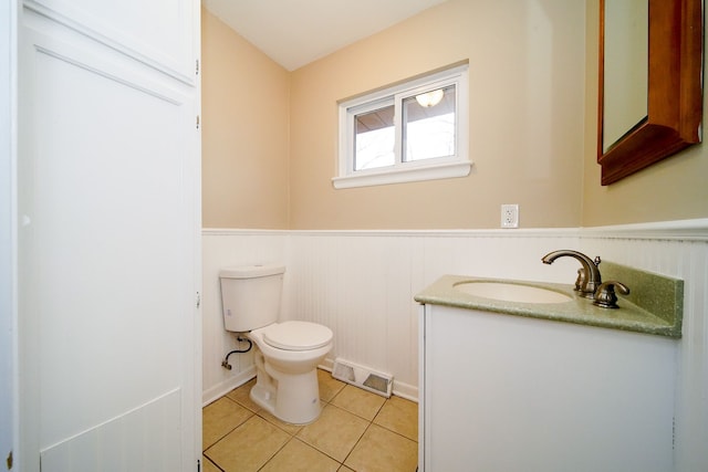 bathroom featuring vanity, tile patterned floors, and toilet