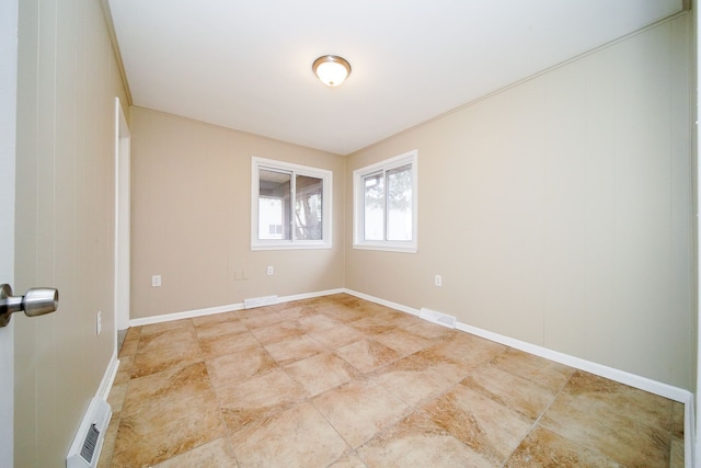 spare room featuring crown molding