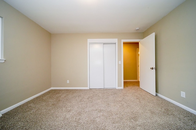 unfurnished bedroom with a closet and carpet