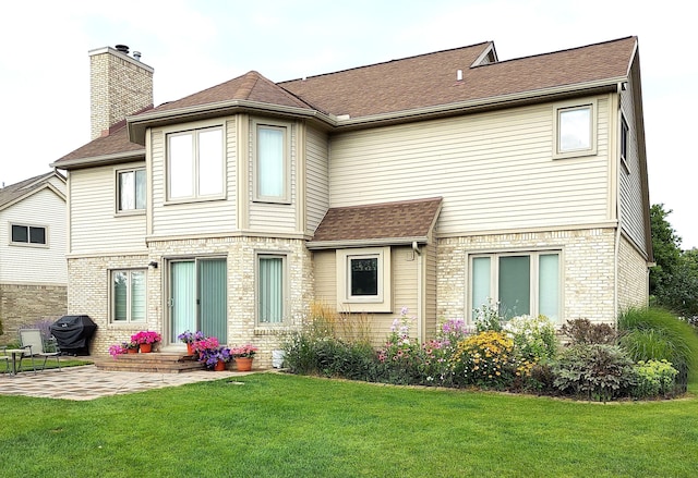 back of property with a patio and a lawn