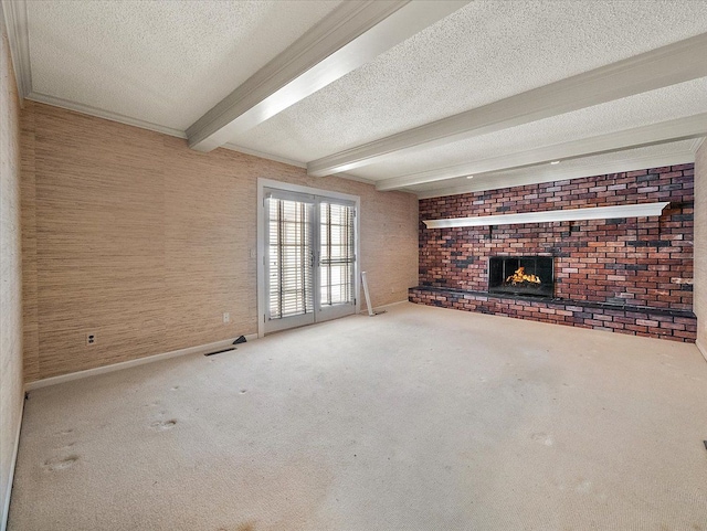 unfurnished living room with a brick fireplace, beamed ceiling, carpet flooring, and a textured ceiling