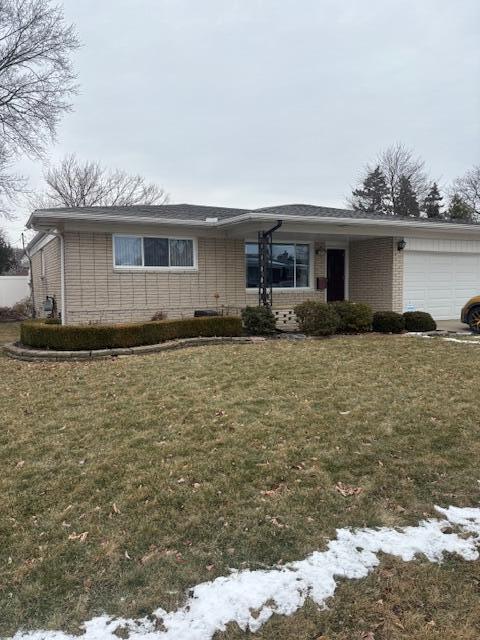 view of front of home featuring a garage and a front lawn