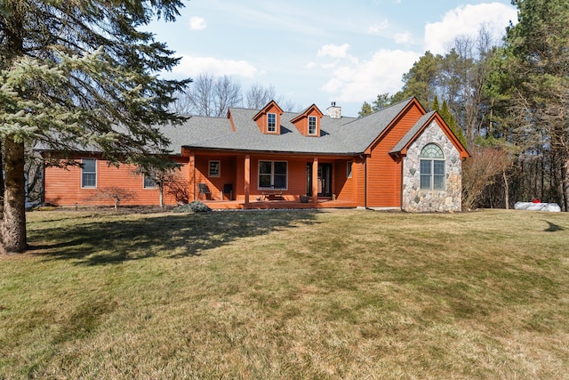 view of front of property with a chimney, stone siding, covered porch, and a front lawn