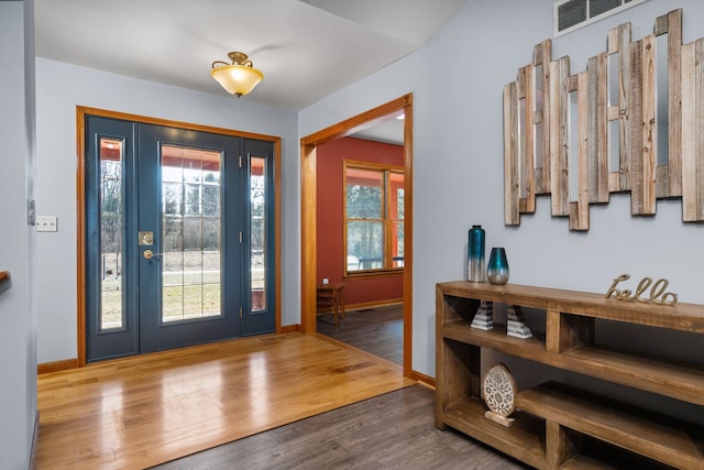 entrance foyer with visible vents, baseboards, and wood finished floors