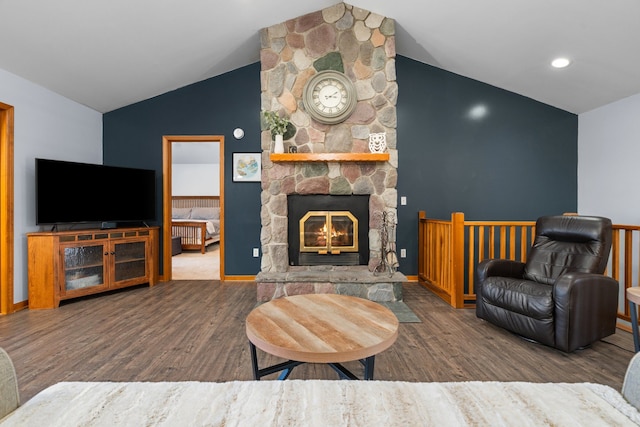 living room with vaulted ceiling, a fireplace, baseboards, and wood finished floors