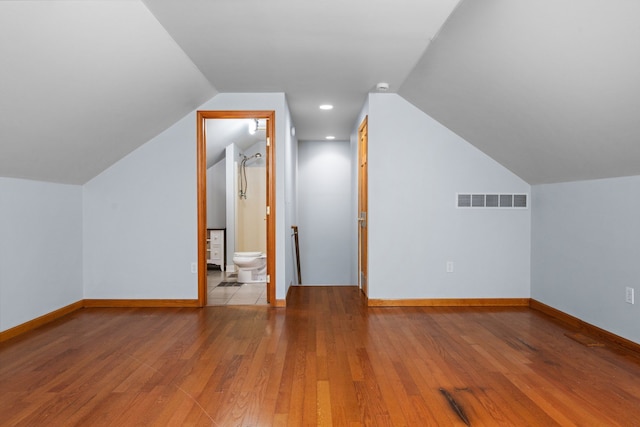 bonus room featuring visible vents, baseboards, and hardwood / wood-style flooring