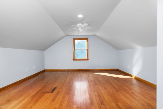 additional living space featuring vaulted ceiling, a ceiling fan, baseboards, and light wood finished floors