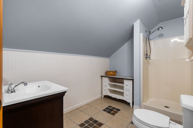 bathroom featuring vanity, tile patterned floors, vaulted ceiling, and walk in shower