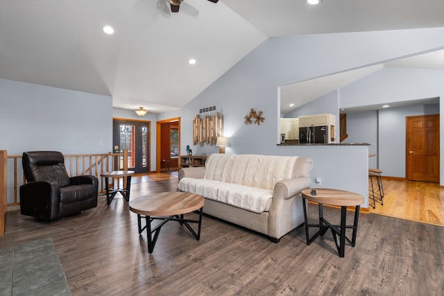 living room with visible vents, recessed lighting, lofted ceiling, and wood finished floors