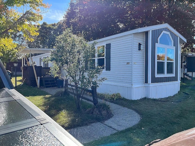 view of side of home with a yard