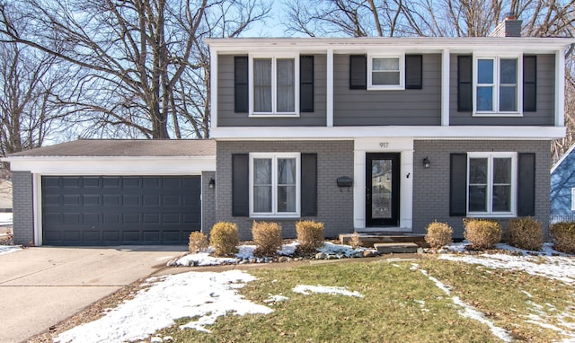 view of front of house with a garage, driveway, brick siding, and a chimney