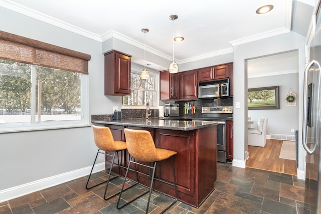 kitchen with stone tile floors, visible vents, appliances with stainless steel finishes, and pendant lighting