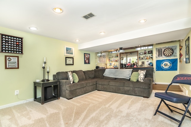 living area featuring baseboards, visible vents, and recessed lighting