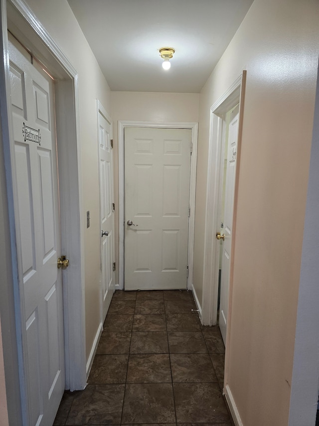 entryway featuring dark tile patterned flooring