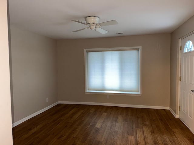 interior space featuring dark wood-style floors, visible vents, baseboards, and a ceiling fan