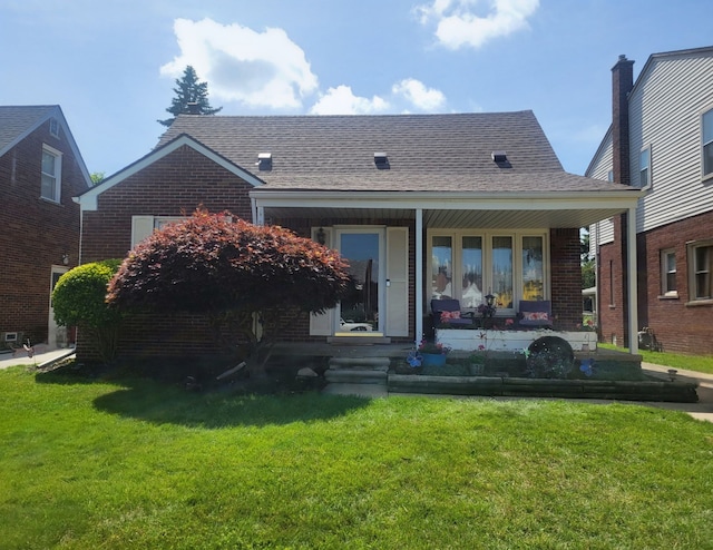 back of property featuring a porch and a lawn