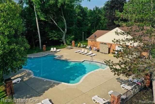 community pool with a patio area