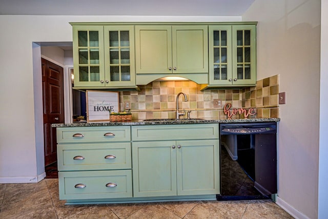 kitchen featuring tasteful backsplash, a sink, dishwasher, and green cabinetry