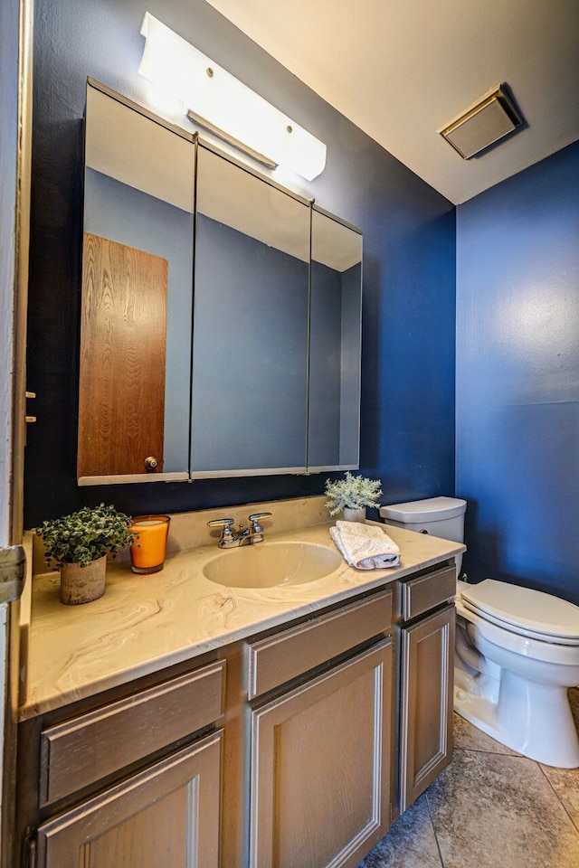 half bathroom with toilet and vanity