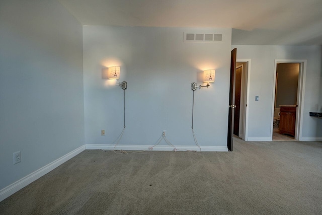 carpeted empty room with visible vents and baseboards