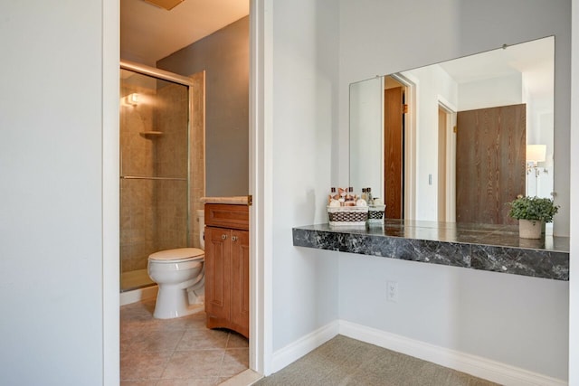 bathroom featuring tile patterned flooring, a shower stall, toilet, and baseboards