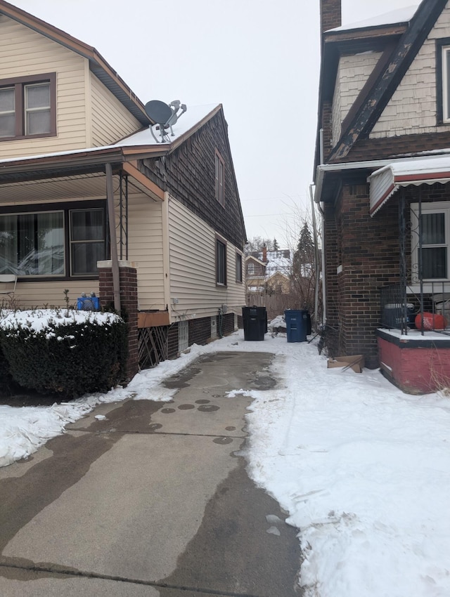 view of snowy exterior with central AC unit