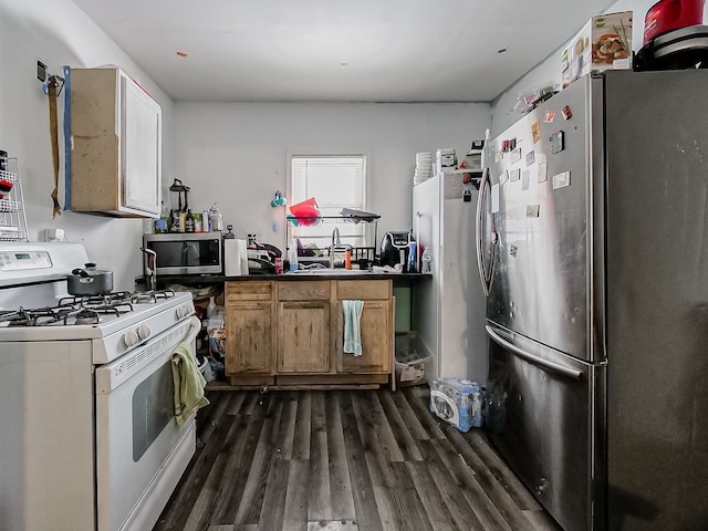 kitchen with stainless steel appliances, brown cabinets, and dark wood-style floors