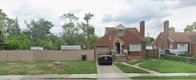 view of front of home with a garage and a front lawn