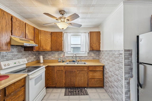 kitchen with white range with electric stovetop, stainless steel fridge, sink, ornamental molding, and ceiling fan