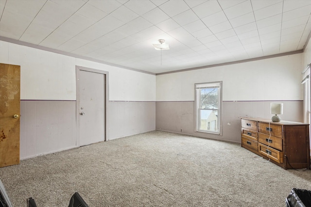 unfurnished bedroom with ornamental molding and light colored carpet