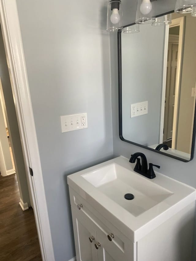 bathroom featuring hardwood / wood-style flooring and vanity