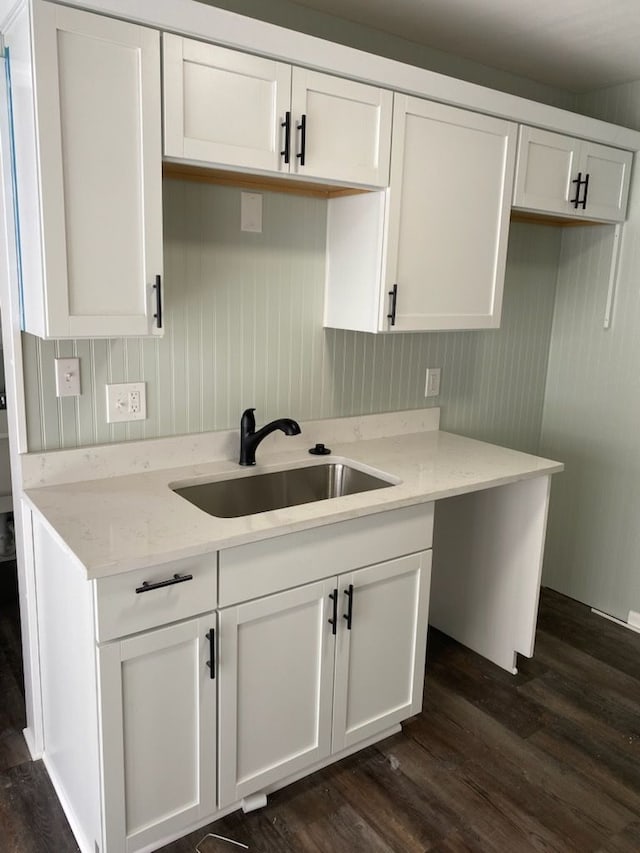 kitchen featuring sink and white cabinets