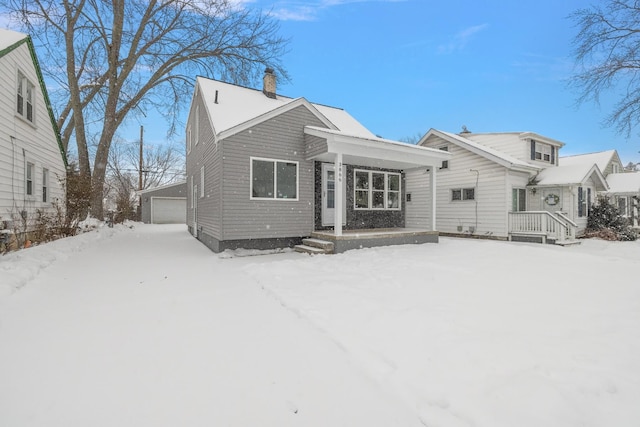 view of front facade with a garage and an outbuilding