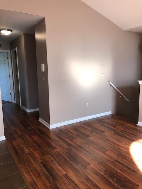 spare room featuring dark wood-type flooring