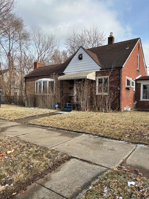 rear view of house with a lawn