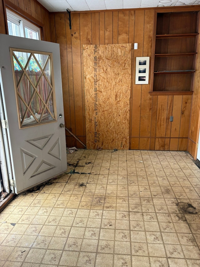 entrance foyer featuring wooden walls