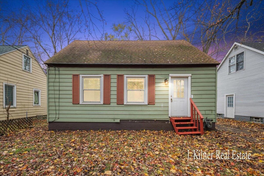 view of back house at dusk