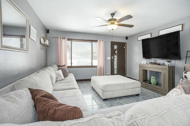 living room featuring plenty of natural light and ceiling fan