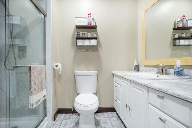 bathroom featuring a shower with door, vanity, and toilet