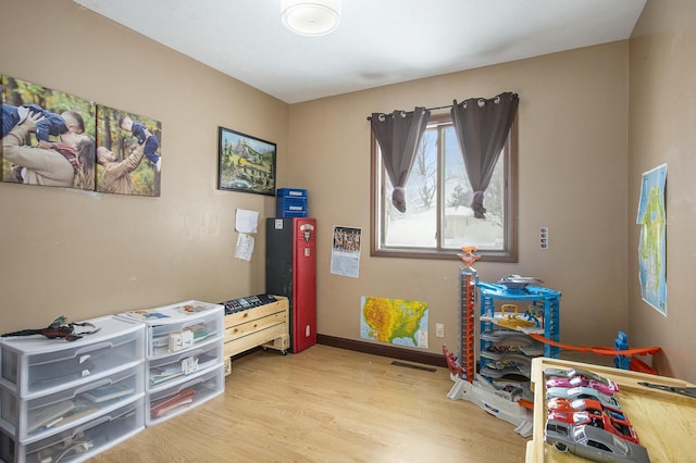 recreation room with light hardwood / wood-style floors