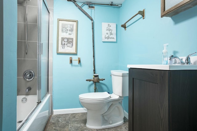 full bathroom featuring enclosed tub / shower combo, vanity, and toilet